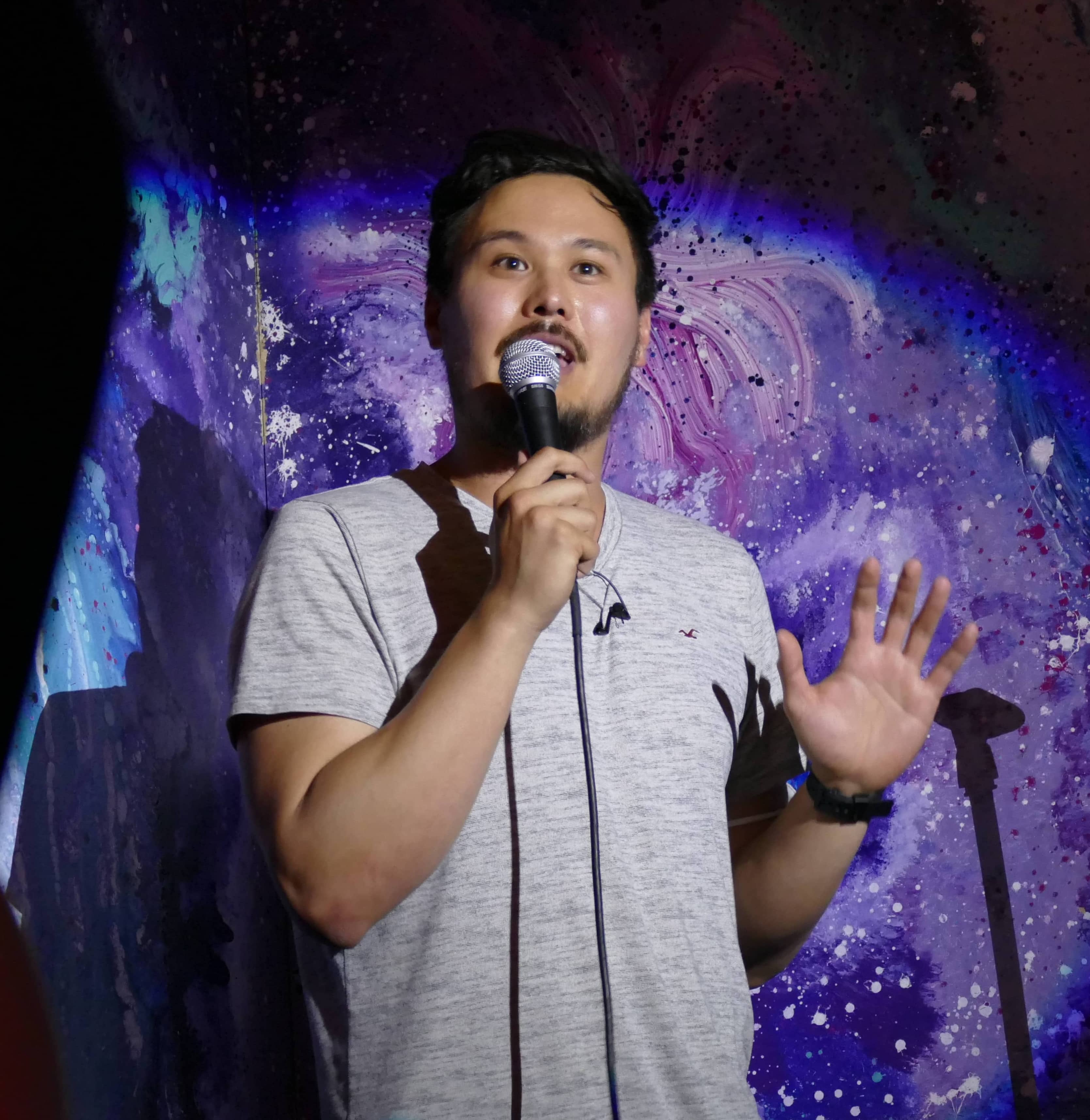 Pascal Hausberger performing stand-up comedy on stage
